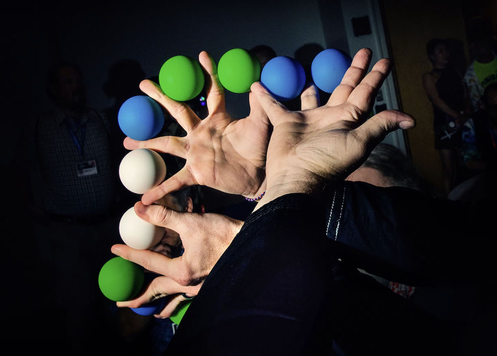 Two hands holding a set of manipulation balls